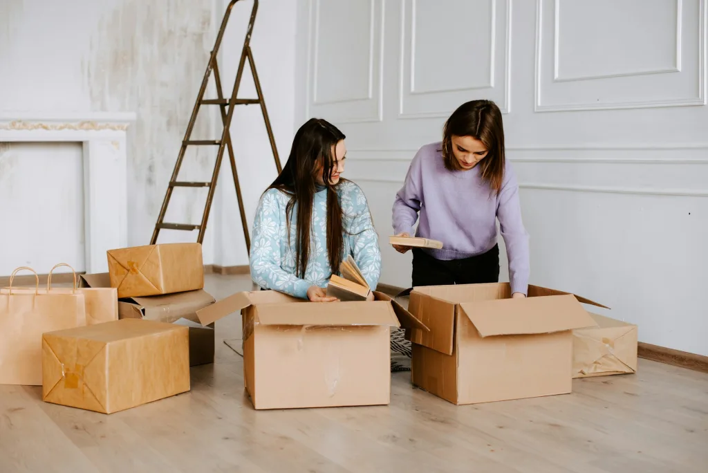 women packing things in moving boxes, Eco-Friendly